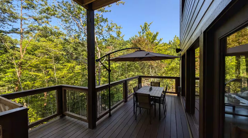 Deck with parasol and seating projecting into the tree canopy